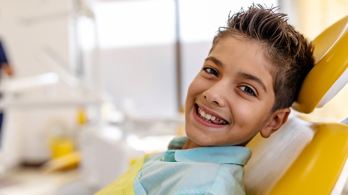 young boy in dental chair smiling